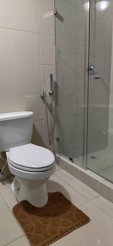 Minimalist bathroom with glass shower enclosure and modern fixtures PH Urbis Tower Panama City