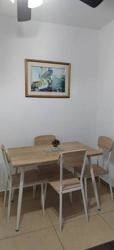 Minimalist dining space with light wood table and plants PH Urbis Tower Panama City