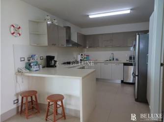 Fully equipped modern open kitchen with island in oceanfront apartment PH Bahía Panama