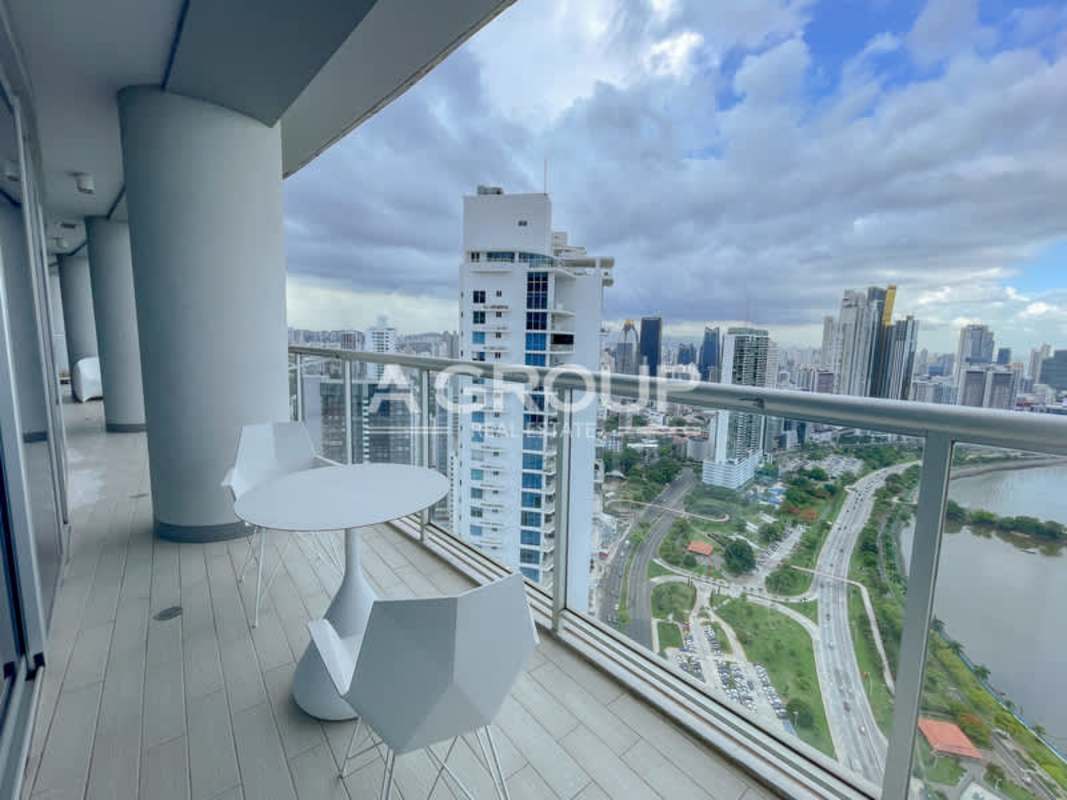 Private curved balcony with glass railings overlooking Cinta Costera, ocean and city in PH Yacht Club Panama