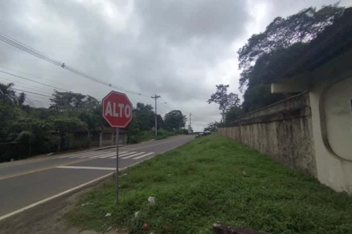 Corner intersection with sidewalk power lines and residential area beside commercial lot Villalobos Panama City