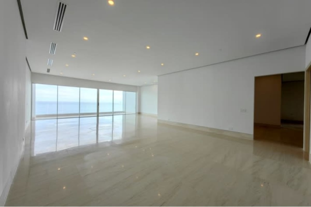 Spacious living-dining area with marble floors, ocean views, minimalist design at Ocean Reef Islands