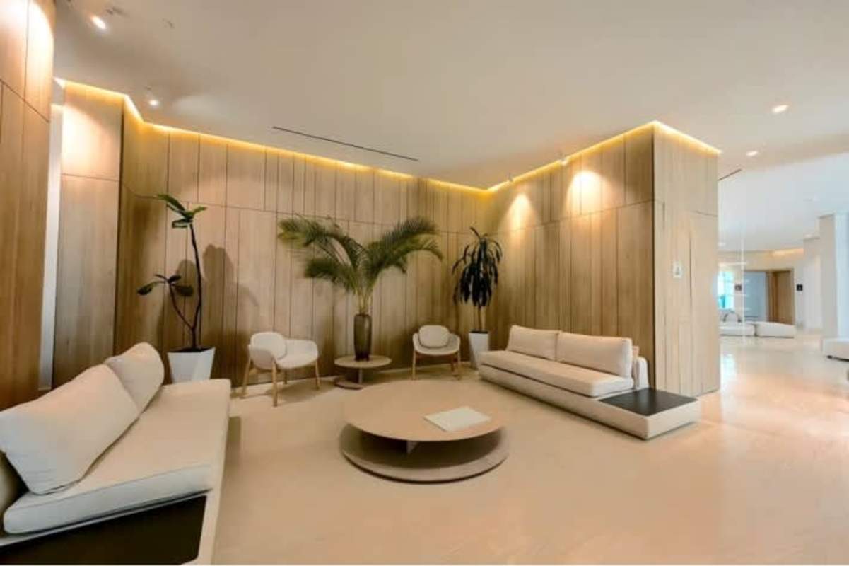 Sleek minimalist marble lobby with wood panel walls in Ocean Reef Residences Panama