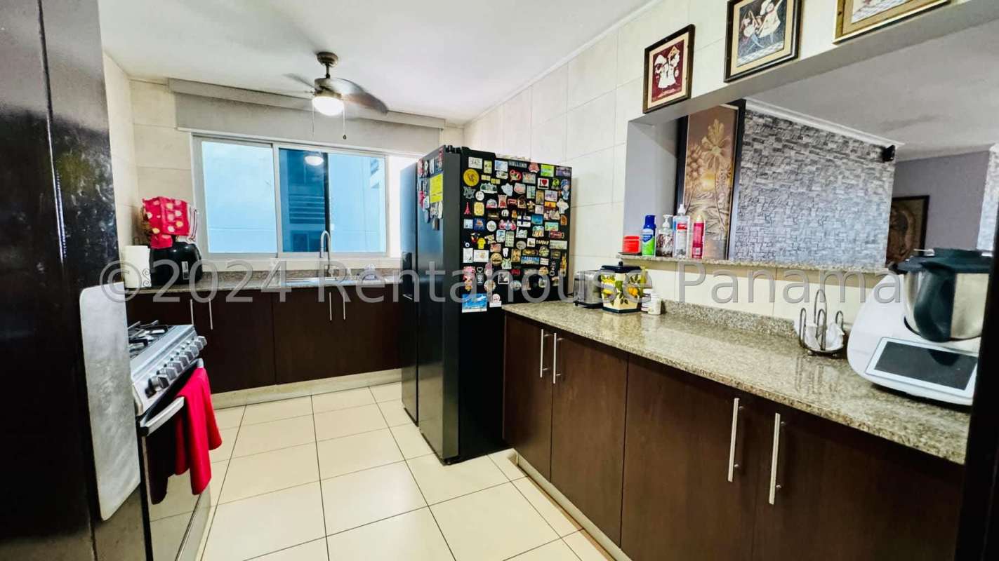 Kitchen with granite counters, breakfast bar, appliances and bright window in PH Constellation Tower Dos Mares Panama