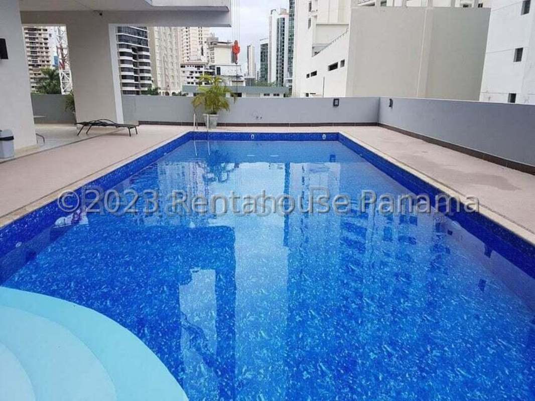 View of infinity swimming pool with skyline ocean backdrop in PH Miramar Tower Panama City