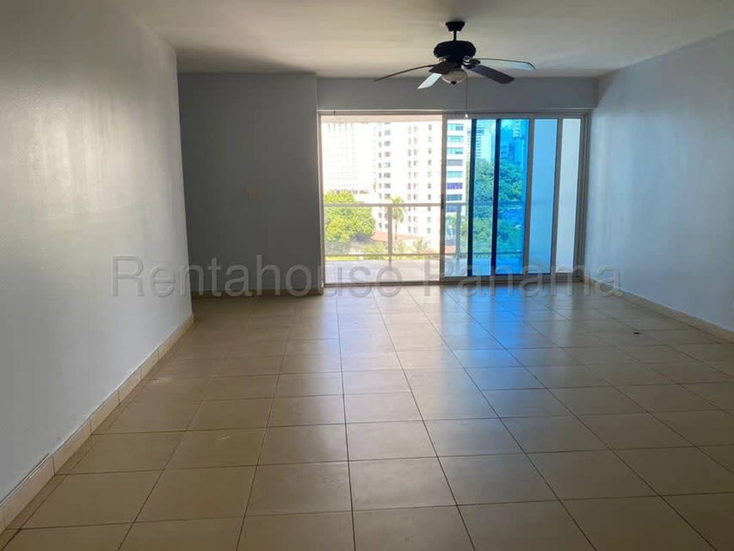 Spacious living and dining room with sliding glass doors to balcony offering city ocean views in PH Miramar Avenida Balboa Panama