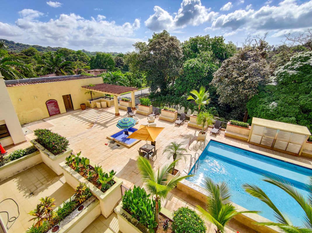Aerial view of Mediterranean pool area with tropical landscaping in Embassy Village Clayton Panama