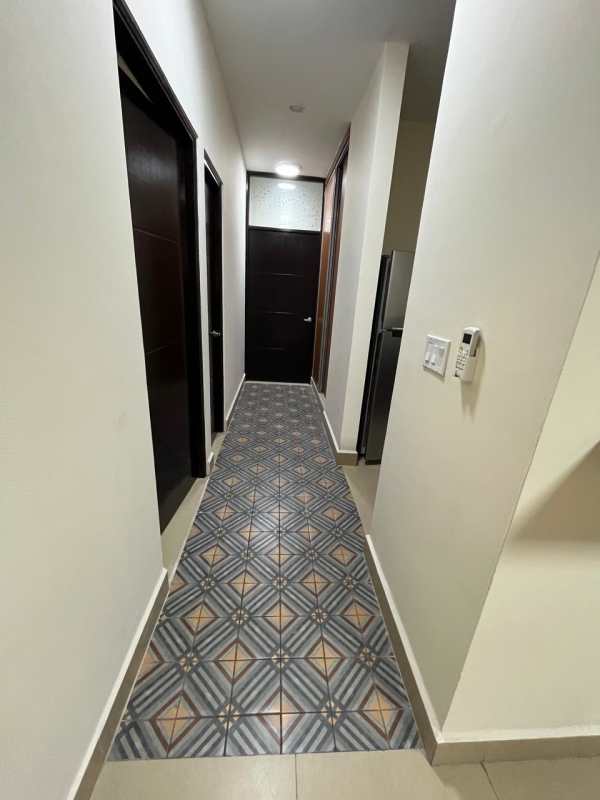 Modern hallway with ceramic floors and wooden doors Embassy Village Clayton Panama City