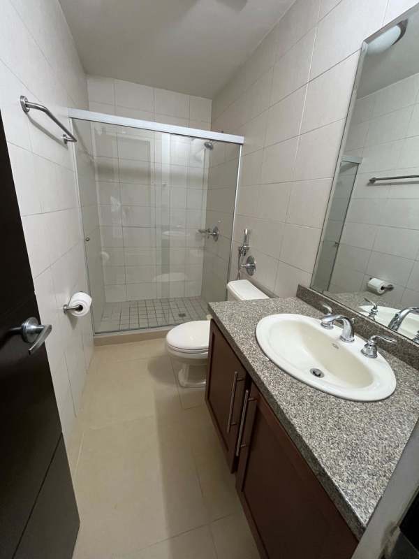 Modern tiled bathroom with granite counter and glass walk-in shower Embassy Village Clayton Panama City