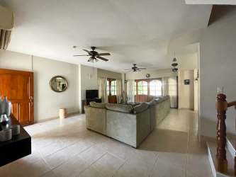 Living room with sectional sofa, ceiling fans, open kitchen, tile floors Playa Blanca