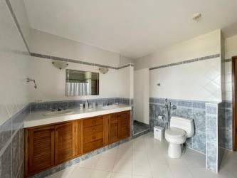 Wood cabinetry kitchen with breakfast bar and dining area Playa Blanca villa beach home