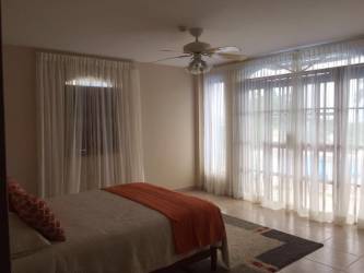 Saltwater lagoon pool with gazebos palm trees ocean views Playa Blanca Resort Panama