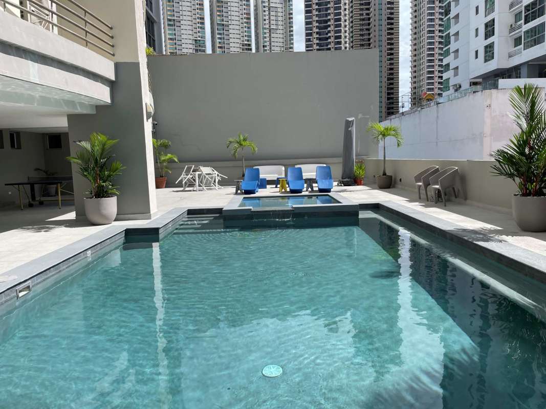 Outdoor pool with sun deck loungers jacuzzi at PH Premier Loft San Francisco Panama