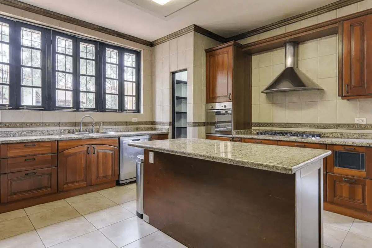 Spacious living room with natural light, parquet flooring, ceiling fan in luxury house Panama City