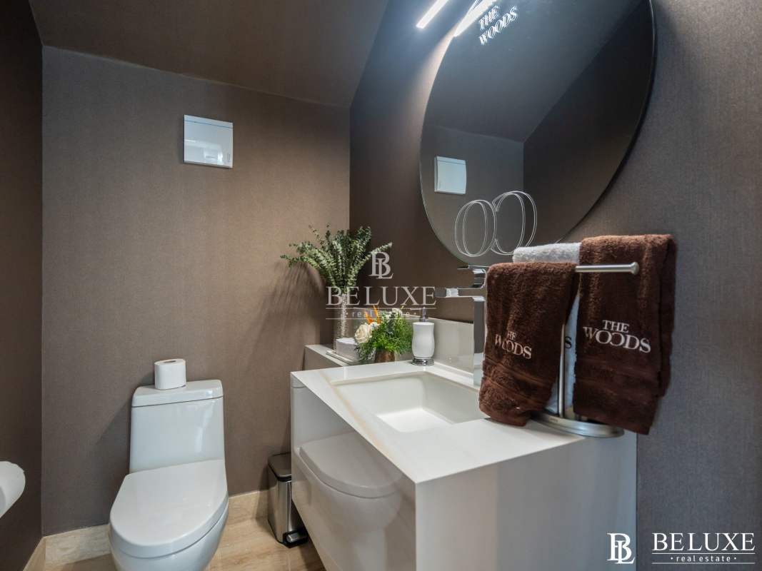 Modern bathroom with sleek fixtures and circular mirror PH The Woods Santa María Golf Panama