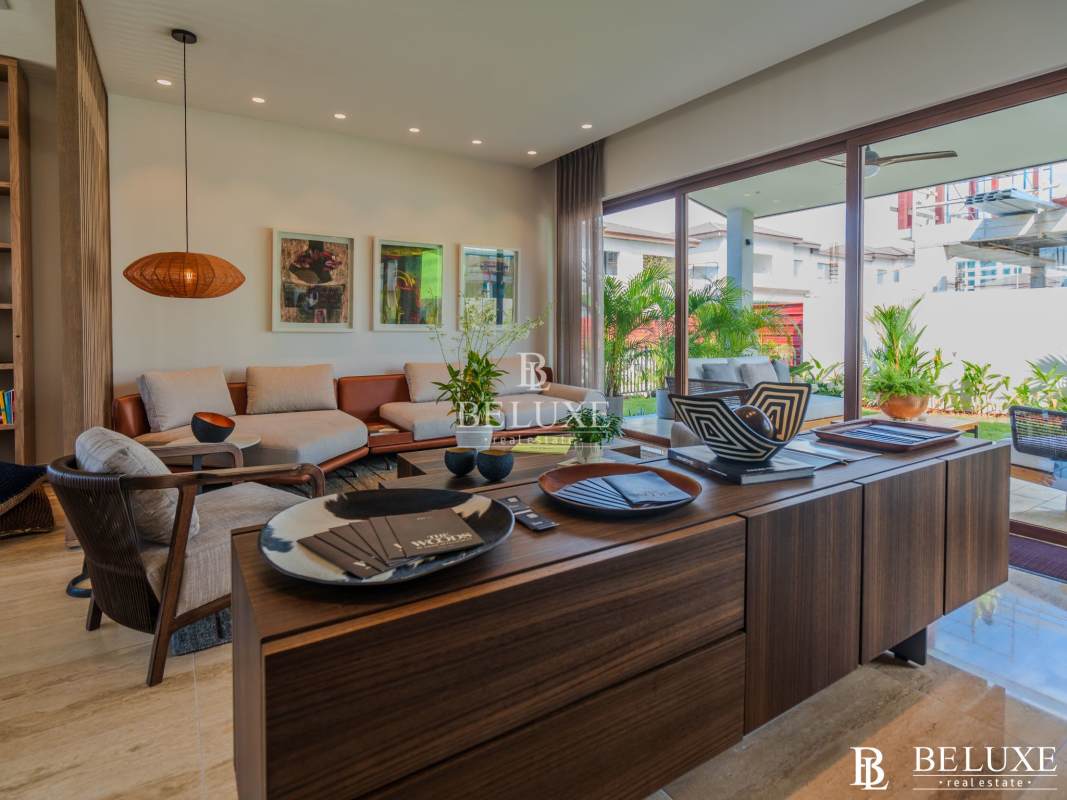 Bright living room with large glass doors contemporary furniture PH The Woods Santa María Panama