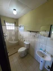 Bathroom with walk-in shower pedestal sink window in Chitré rental house Panama