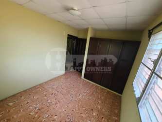 Bedroom with built-in wardrobe drop ceiling beige wall in Chitré Panama