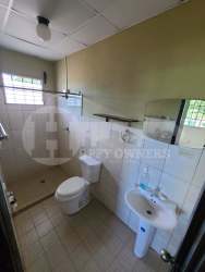 Small bathroom tiled walls walk-in shower window in Chitré Panama rental house