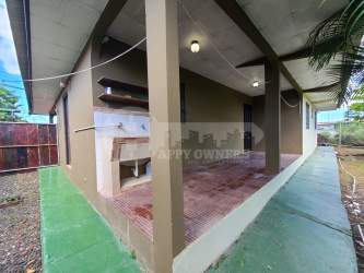 Spacious backyard with green lawn mature trees residential house Chitré Panama