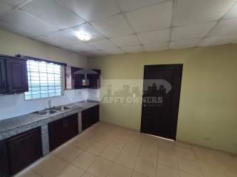 Kitchen with wooden cabinets granite countertop double sink Chitré house rental Panama