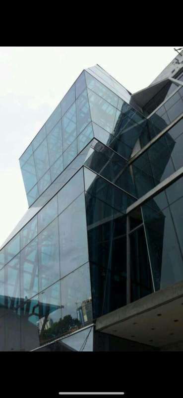 Blue neon 'Le Blue' sign and glass modern exterior night view office Panama City