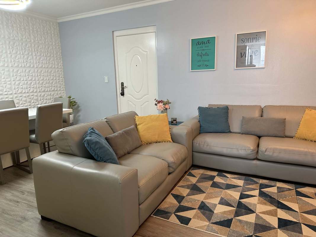 Modern living room with beige sofas, textured wall, colorful pillows in PH Bella Vista Panama