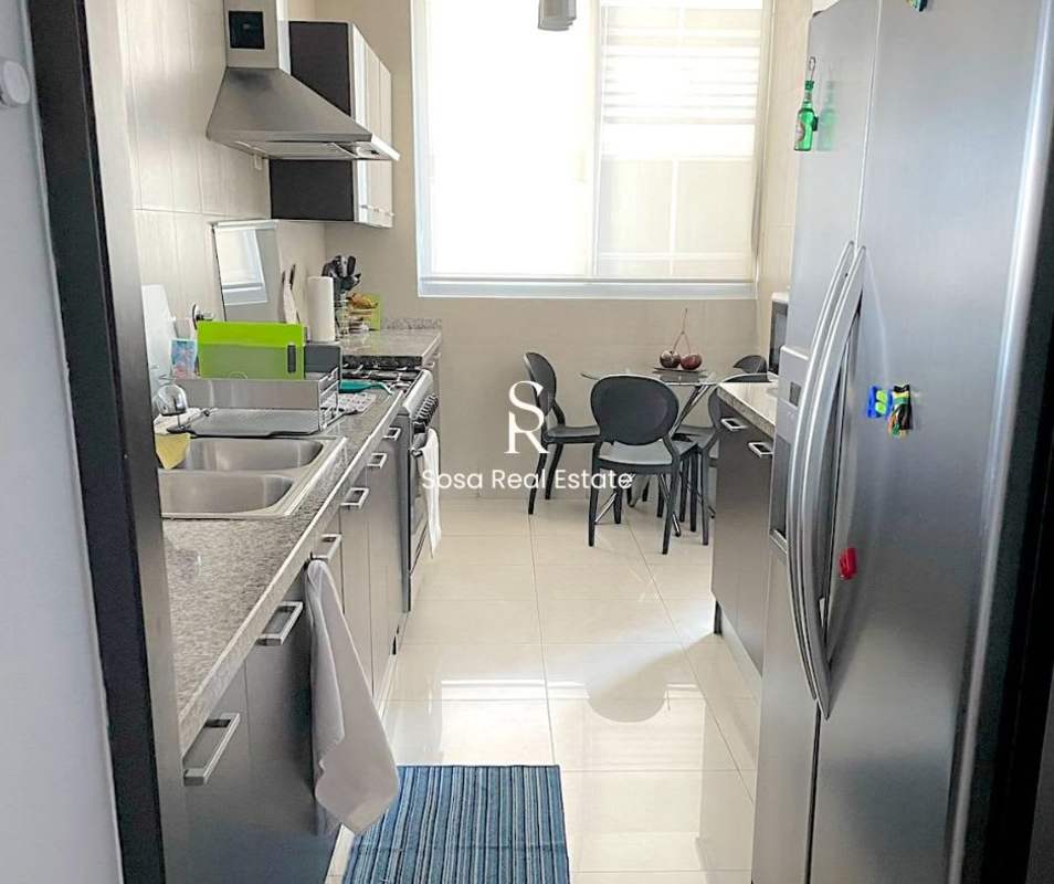 Kitchen area with granite counter, sink, appliances, and breakfast table PH San Francisco Park View Panama