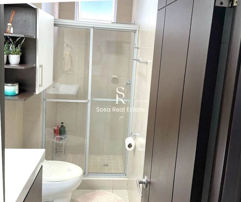 Modern bathroom with shower enclosure, vanity, beige tiles for sale apartment Panama