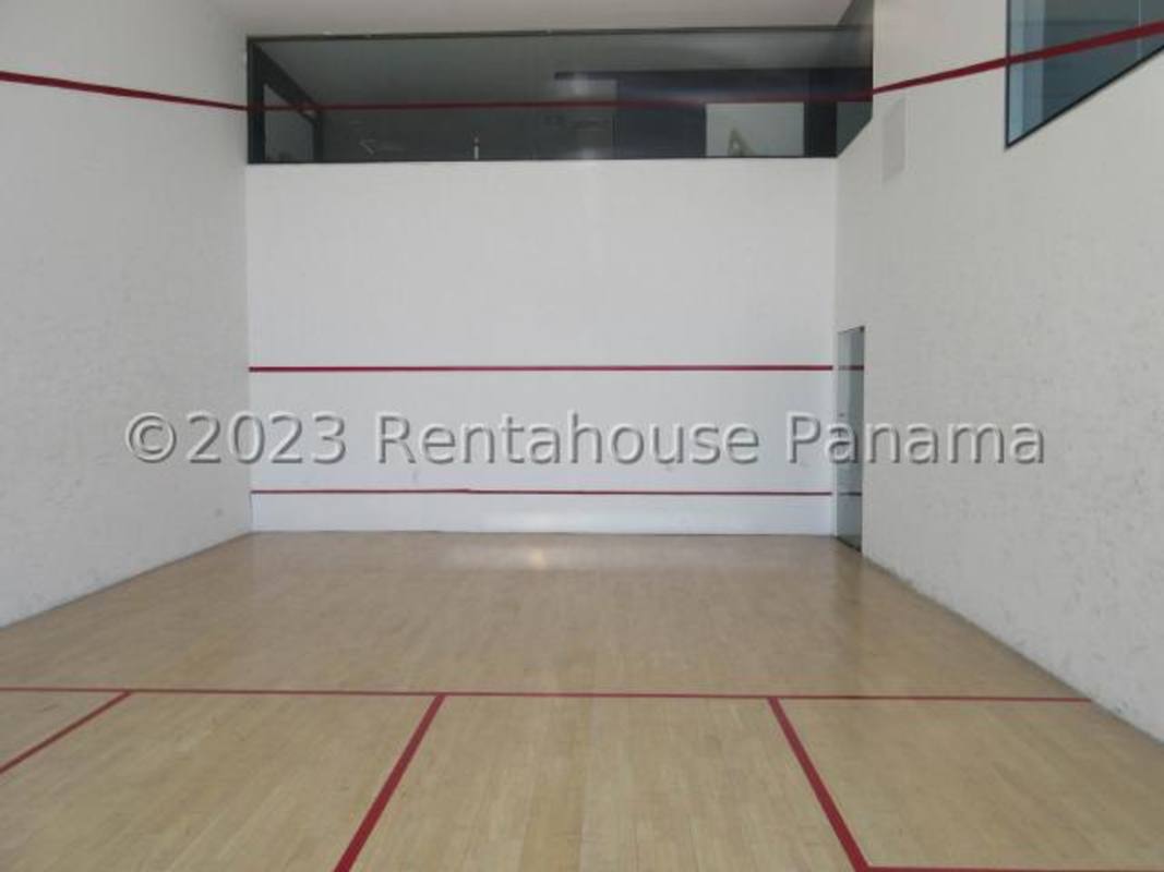 Indoor squash court with wooden floor and glass viewing area at PH Coco del Mar Panama
