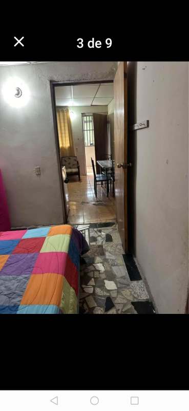 View from bedroom into dining area colorful bedding in budget rental Pedregal Panama