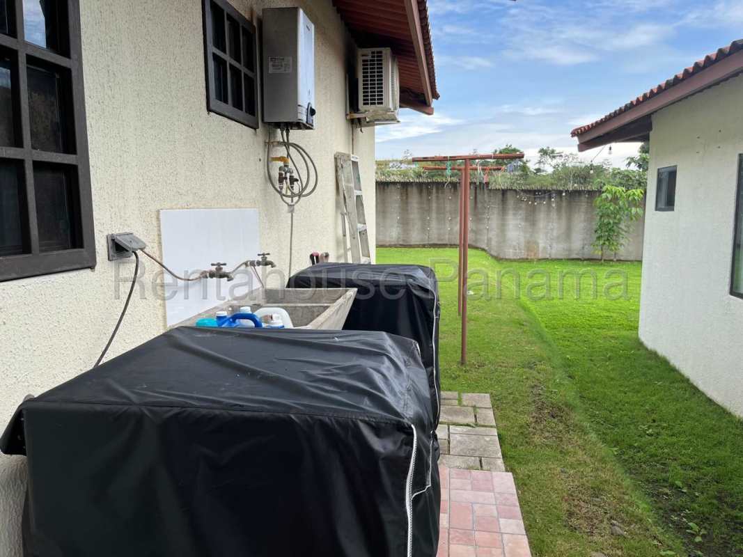 Kitchen with granite countertops and wood cabinets in house for sale PH Vistas del Lago Panama City