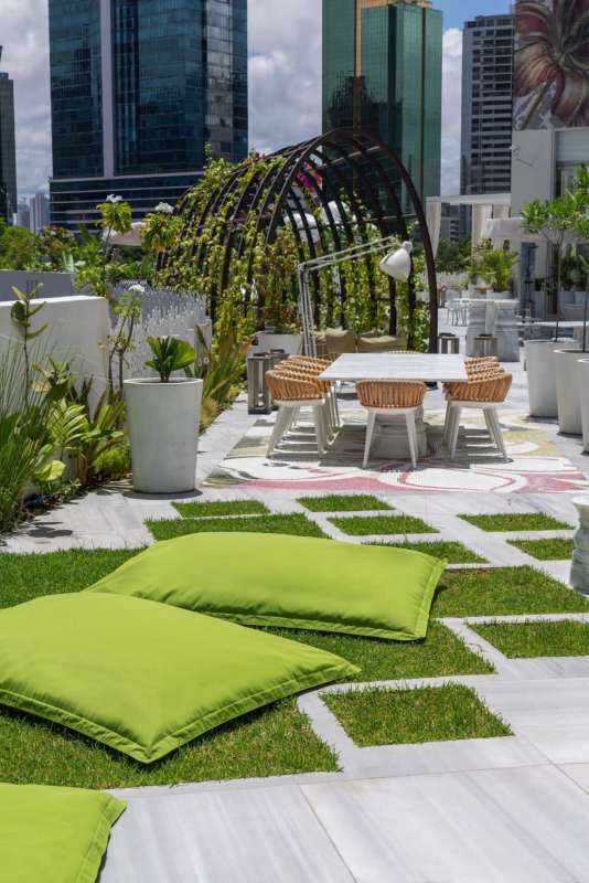 Infinity pool with designer floral mosaic overlooking Panama skyline at PH Wanders & Yoo