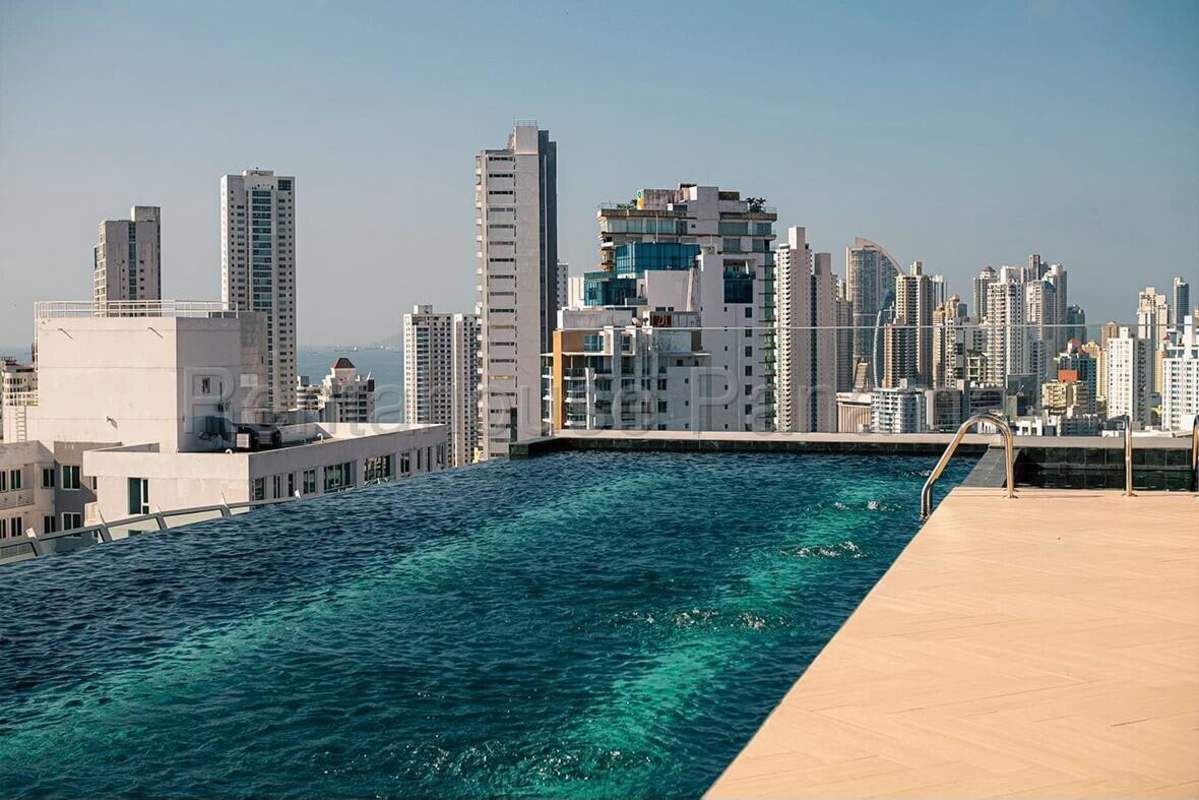 Rooftop infinity swimming pool with panoramic ocean and skyline views at PH Victory Tower Panama City
