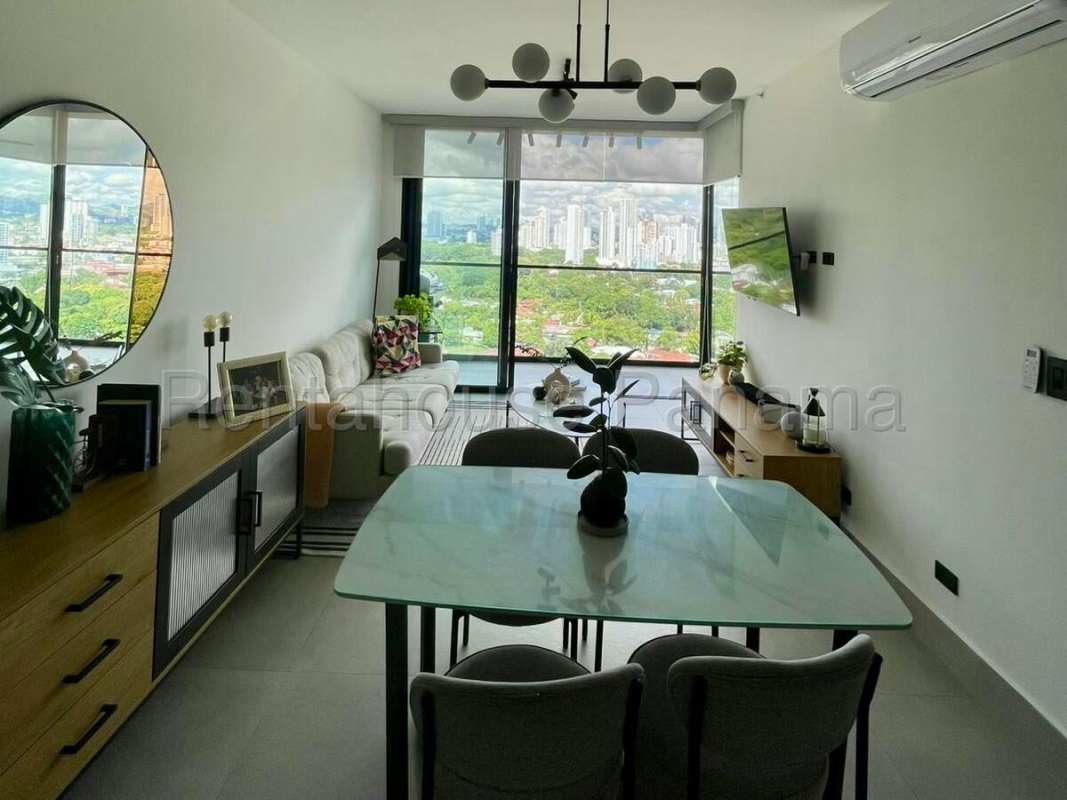 Bright living and dining area with panoramic city view at PH Victory Tower Coco del Mar Panama City