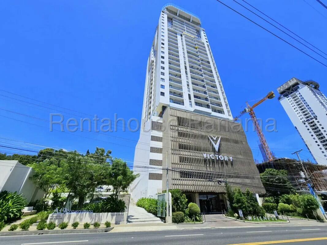 Modern high-rise condo building Victory Tower with balconies and landscaped entrance Panama City