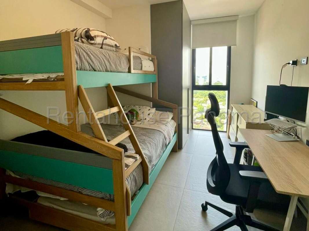 Bright modern bedroom with workspace and skyline views in Victory Tower Coco del Mar Panama