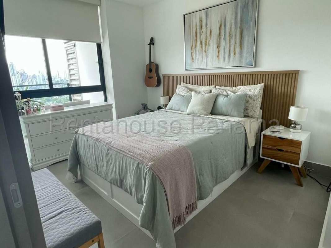 Contemporary bedroom with large window, closet, and skyline view in Victory Tower Panama