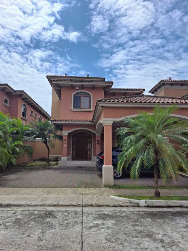 Two-story house Mediterranean facade with carport and palm trees in El Doral Costa Sur Panama