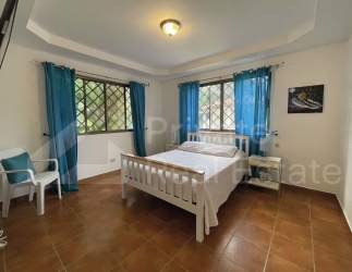 Mediterranean styled facade with terracotta roofs and garden at luxury Punta Barco property.