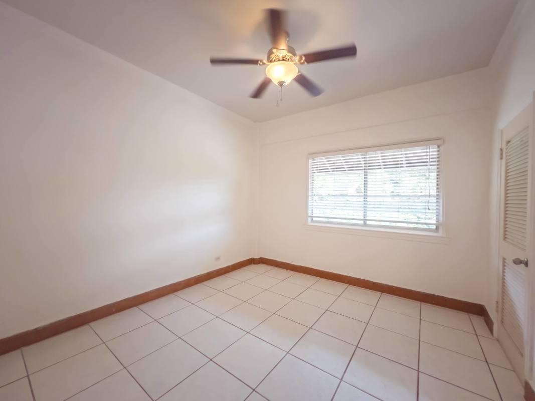 Bright bedroom with wall fan and white tiles for rent Clayton Panama