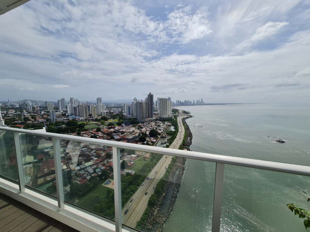 Spacious main bedroom with large closet space floor-to-ceiling windows ocean skyline view in Punta Pacifica Panama