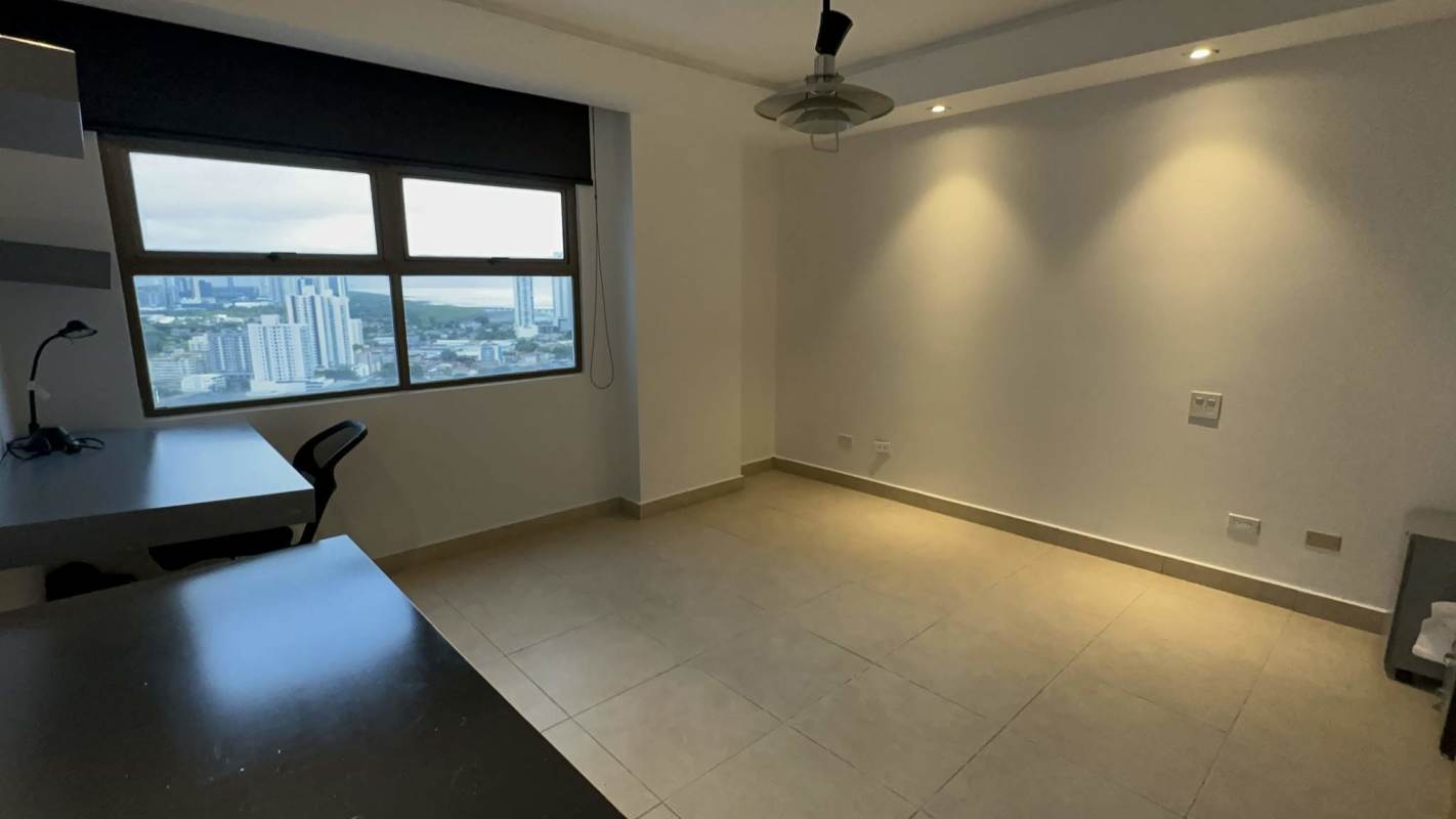 Modern bedroom or office space with large city-view window, ceiling fan and tile floors in penthouse Panama