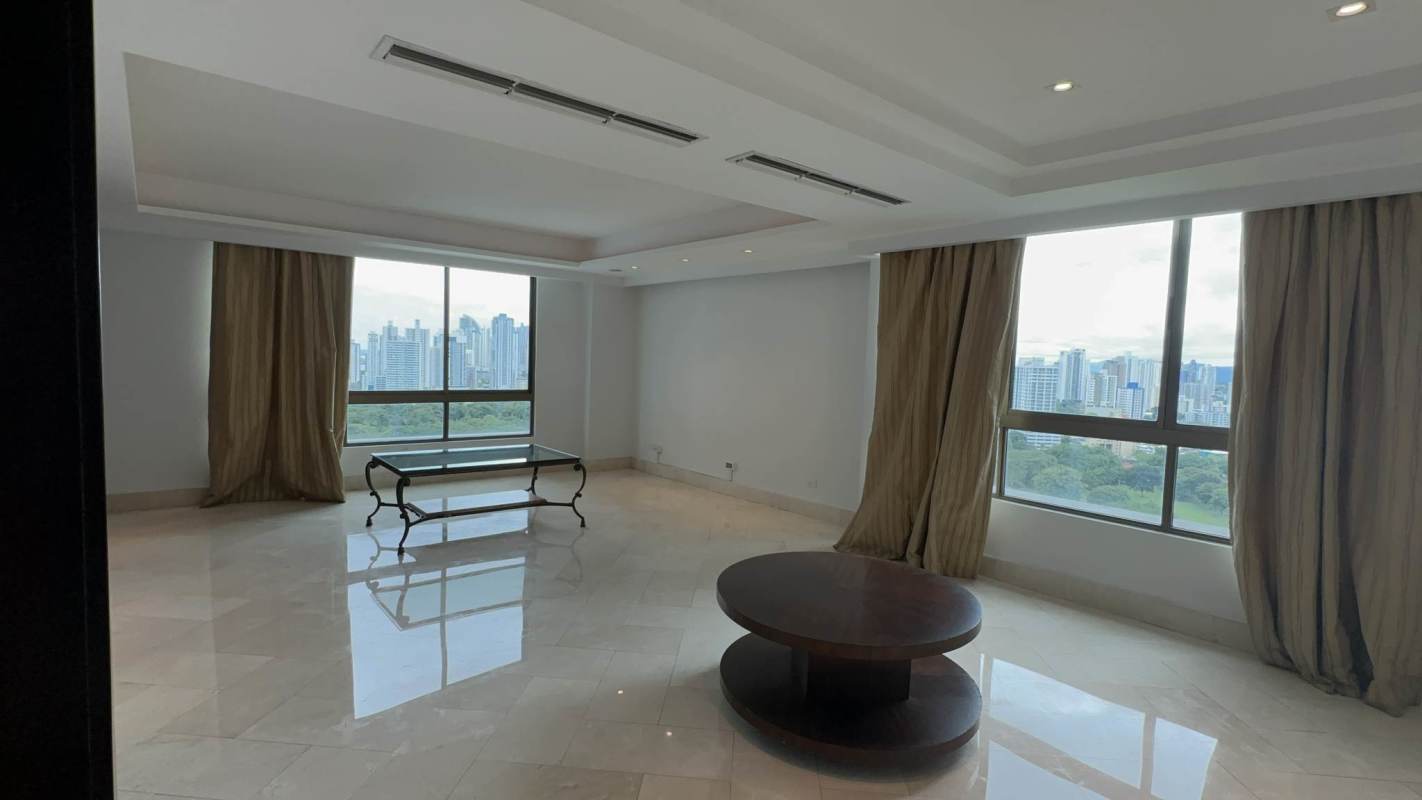 Modern penthouse apartment with city skyline view, marble floors, and chandelier lighting in Panama City