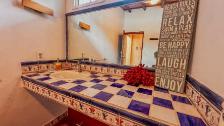 Blue white checkered tile bathroom with large mirror in Malibu beach house Gorgona
