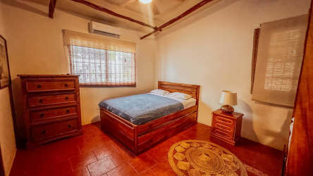 Living room with blue cushioned tile seating built-ins tropical beach home Gorgona