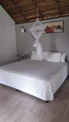 Rustic-style restaurant bar area with brick wall, liquor shelves, chalkboard menus at tourist complex in Chiriquí