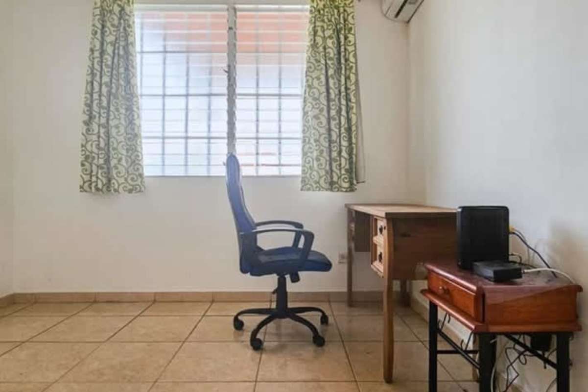 Bright home office room with window and AC minimalist design in Brisas del Occidente Panama