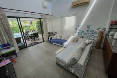 Living area open to pool deck with large glass doors Punta Paraíso beach house