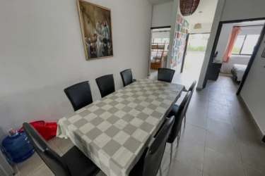 Modern dining room with tile flooring and black chairs in Coronado beach villa